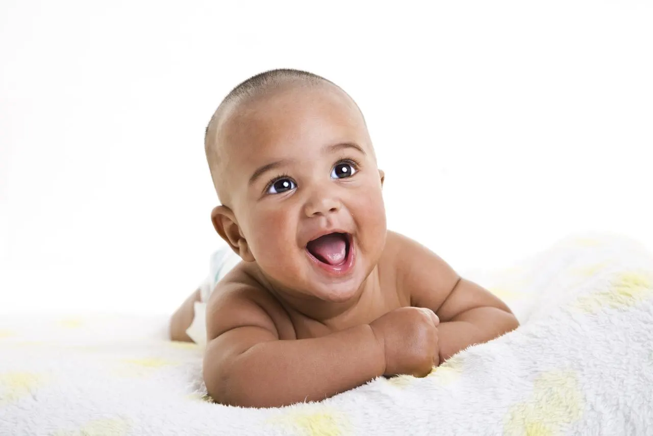 Smiling baby lying on a blanket