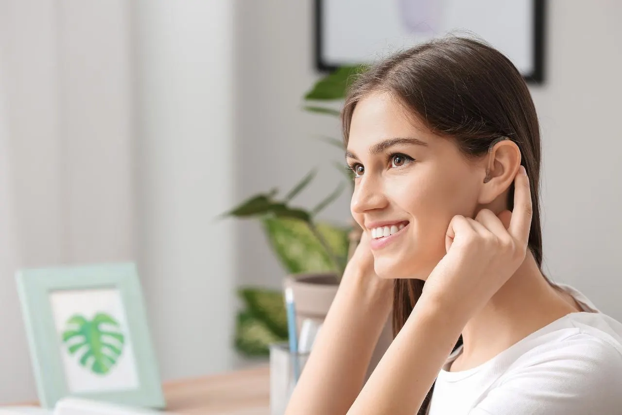 Smiling woman touching her ear